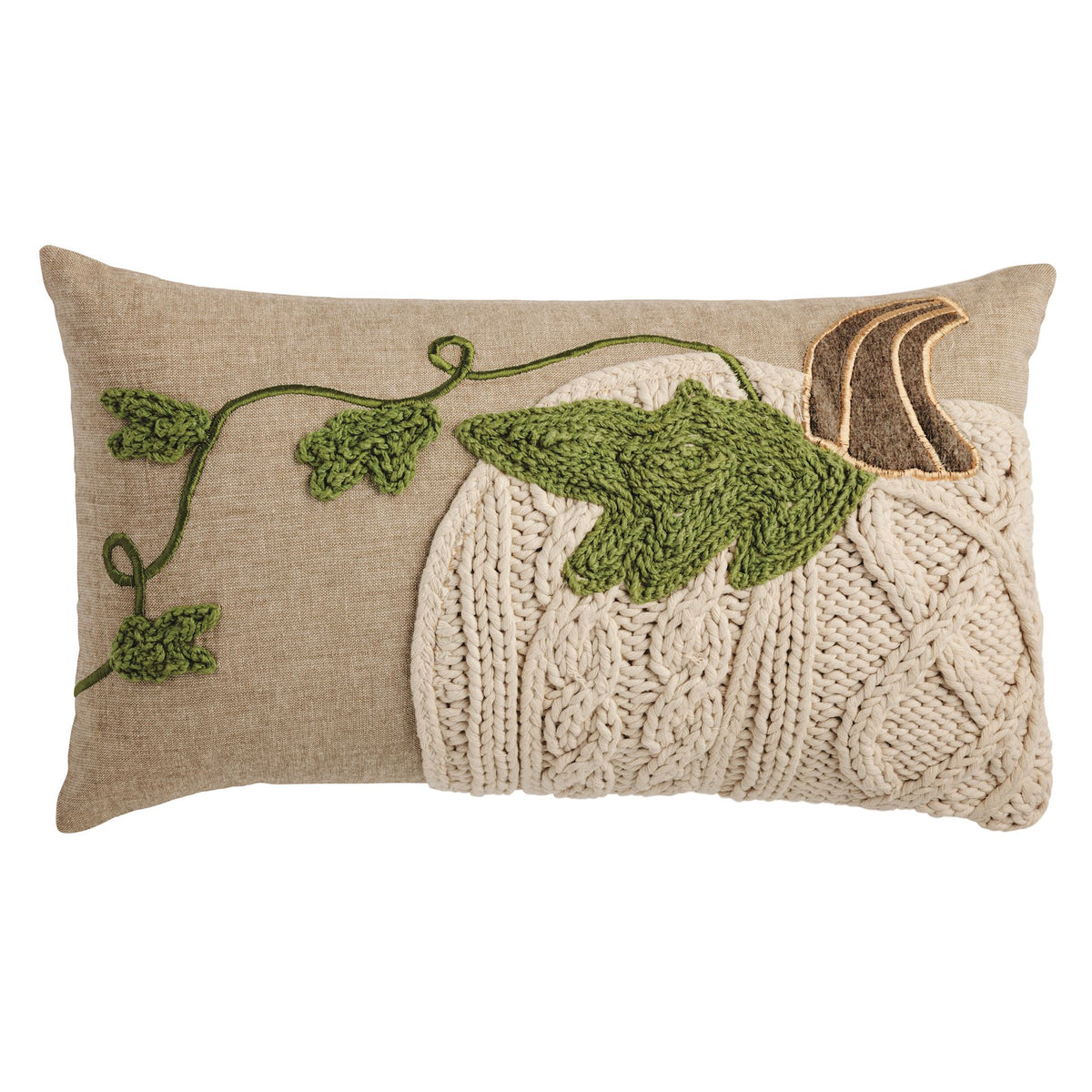 Decorative pillow with knitted pattern and green leaves on a beige background