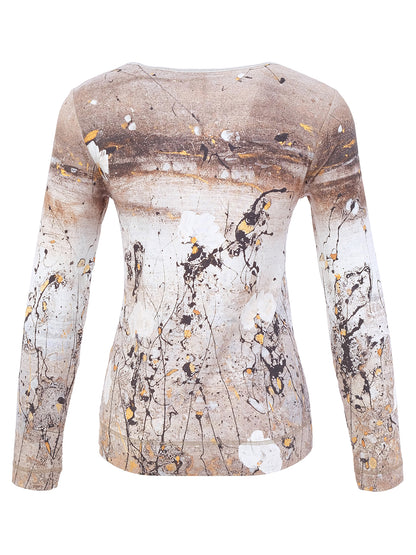 A long-sleeve crewneck top featuring an abstract paint splatter and brushstroke pattern in beige, brown, white, and black with small gold accents, displayed on a ghost mannequin against a white background.
