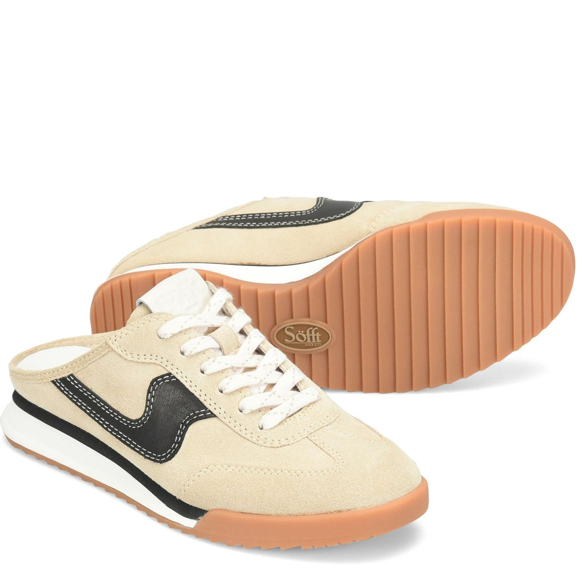 A pair of beige low-top sneakers with black side stripes, white laces, and gum soles, shown on a clean white background. One shoe is positioned in front showing the side profile, and the other is behind showing the treaded sole with a visible 'Soft' brand logo.