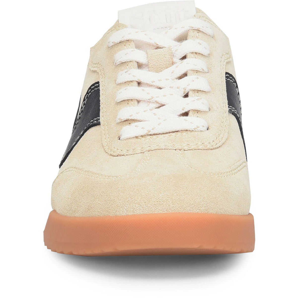 A close-up rear view of a low-top sneaker in beige suede with white laces, black side stripes, and a gum brown sole, shown on a white background.