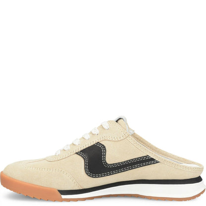 A low-top sneaker slip-on mule in beige suede with a black side accent, white laces, a white midsole, and a gum brown outsole, shown from a side profile on a white background.