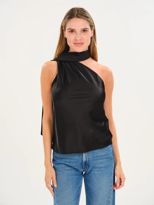 A woman modeling a black satin-like halter top with a draped neck and side tie detail, paired with blue jeans, against a plain white studio background.